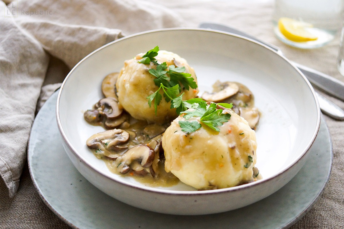 Homemade potato Knödel with a crispy golden crust, served alongside a hearty goulash